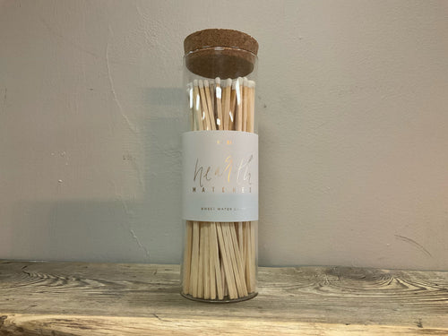 Front view of white hearth matches - glass jar