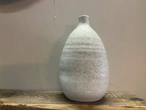 Front view of distressed terracotta vase with glaze
