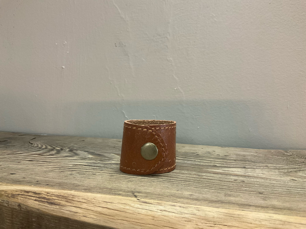 Front view of leather napkin ring brown with snap