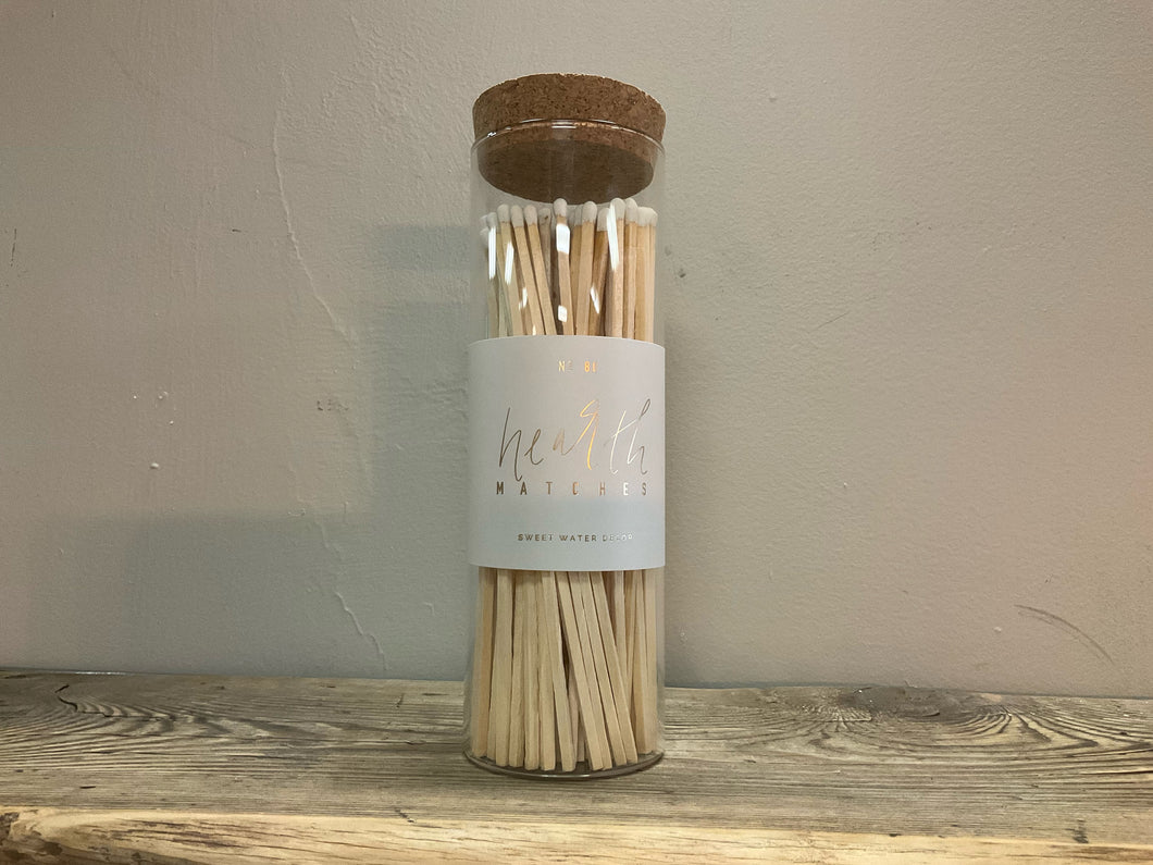 Front view of white hearth matches - glass jar