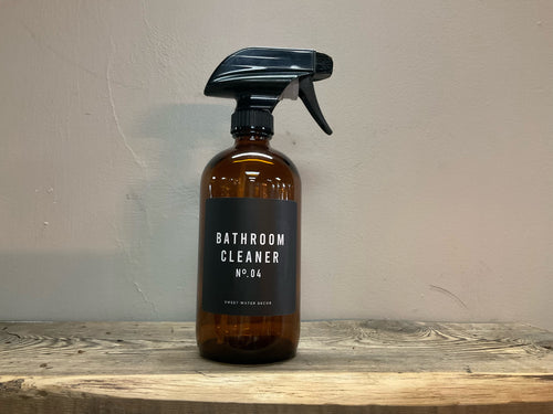 Product shot of 16oz amber glass bathroom cleaner spray bottle - black label