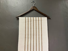 Load image into Gallery viewer, Product shot of taupe w/ tan and vavy table runner 13x72 in a hanger
