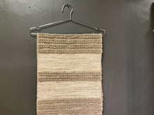 Load image into Gallery viewer, Hanging image of taupe table runner-hand woven 14x72 in a hanger
