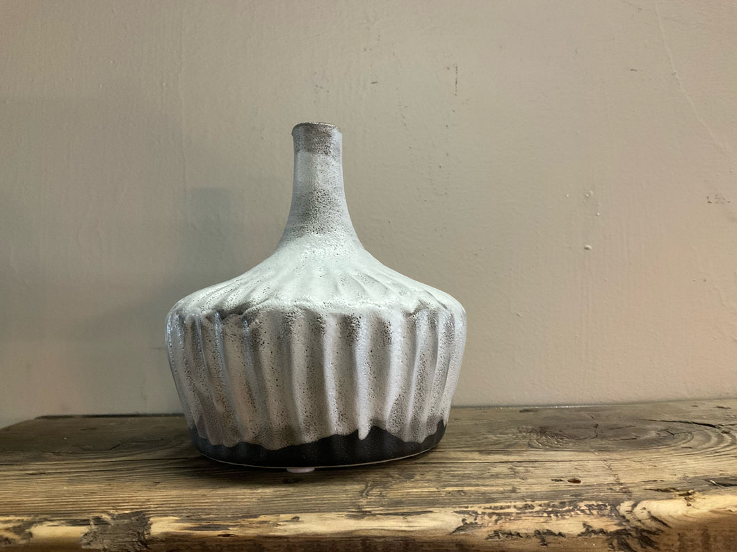 Product shot of stoneware fluted vase, distressed reactive glaze